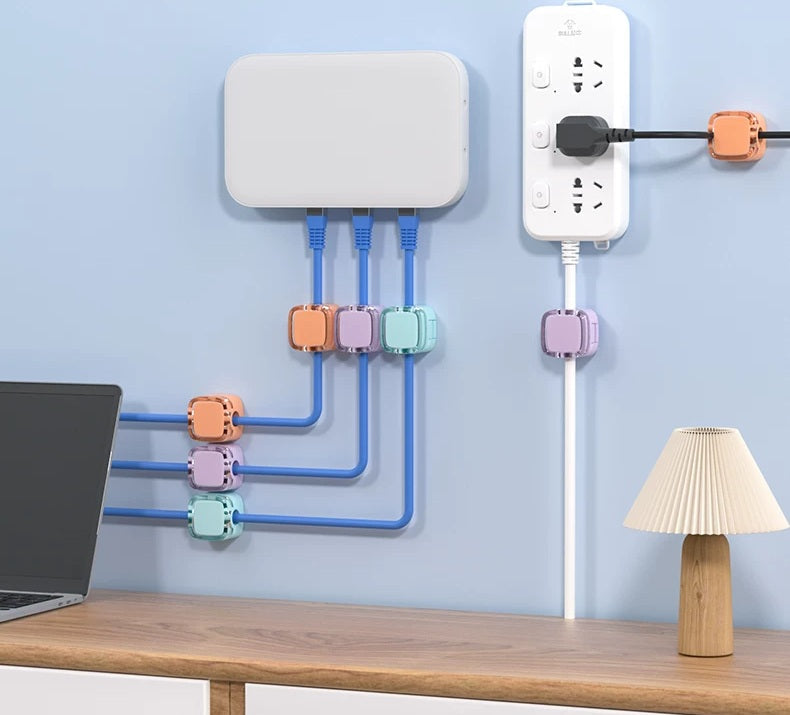 Colorful adhesive wire organizers used on a nightstand and desktop